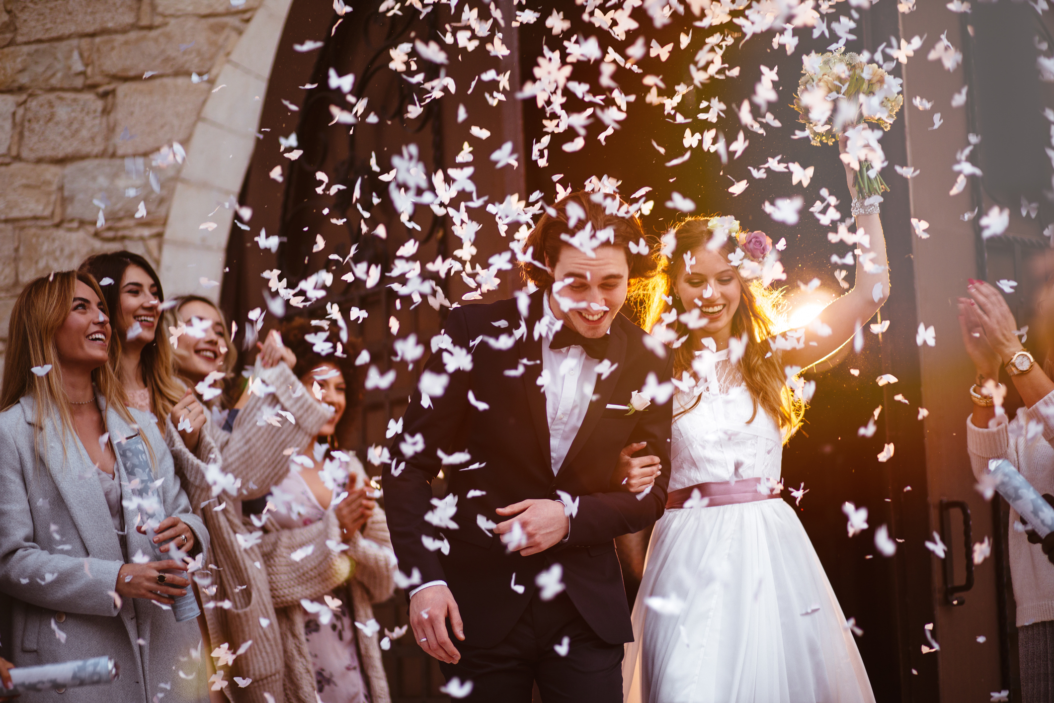 Happy bride and groom leaving church and celebrating
